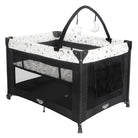 Full view of the Cosco Kids Origins Plus Playard on a white background, featuring a zip-on bassinet, side pocktets, and toy arch.